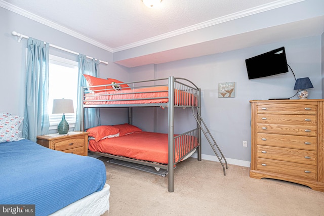 carpeted bedroom with ornamental molding and a textured ceiling