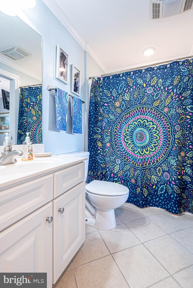 bathroom featuring vanity, toilet, crown molding, and tile patterned floors