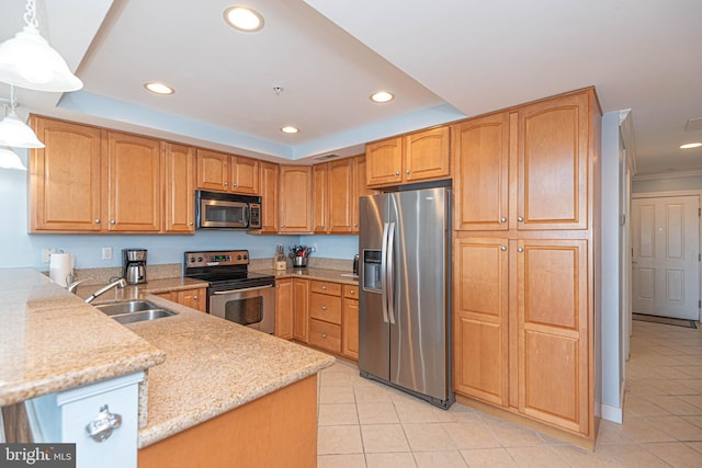 kitchen featuring kitchen peninsula, hanging light fixtures, stainless steel appliances, sink, and light stone counters