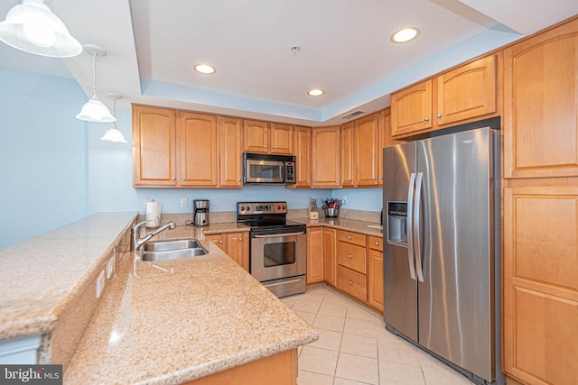 kitchen featuring sink, stainless steel appliances, pendant lighting, light stone counters, and light tile patterned floors