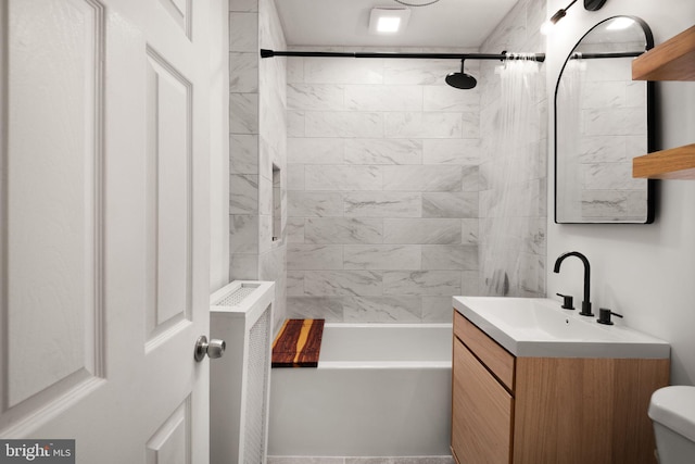 full bathroom with vanity, tiled shower / bath combo, and toilet