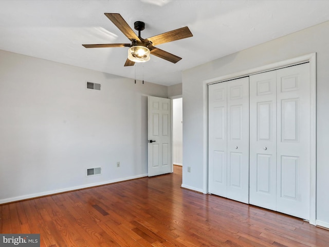 unfurnished bedroom with hardwood / wood-style floors, ceiling fan, and a closet