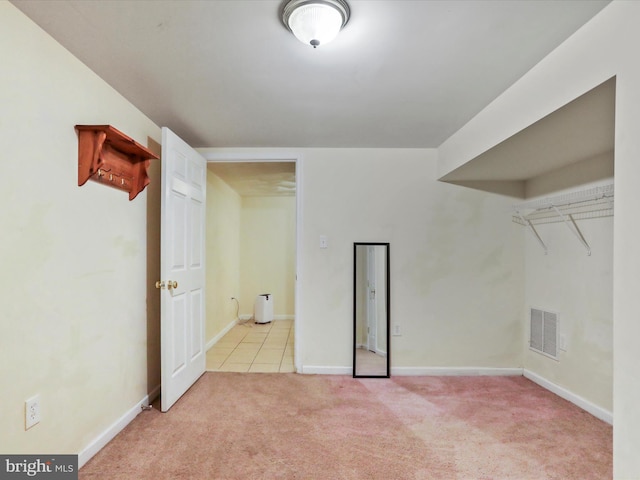 unfurnished room featuring light carpet