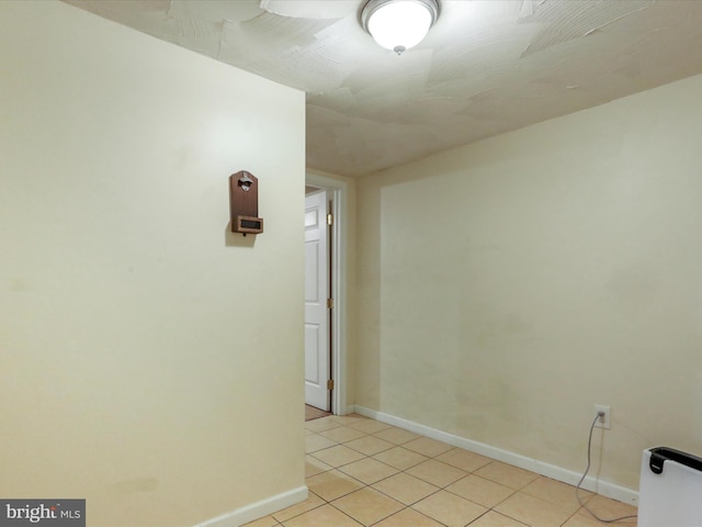 unfurnished room with light tile patterned floors