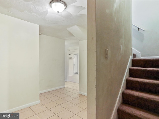 stairs with tile patterned flooring