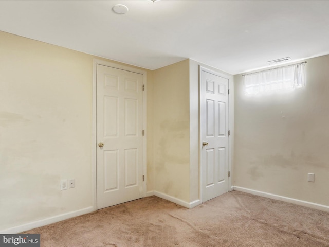 unfurnished bedroom featuring light carpet