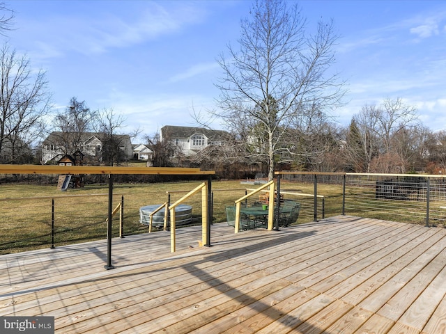 wooden terrace with a yard