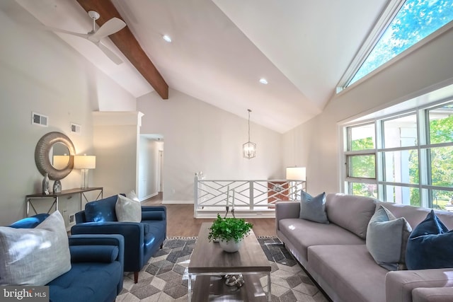 living room with beamed ceiling, hardwood / wood-style floors, ceiling fan with notable chandelier, and high vaulted ceiling