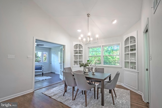 dining area featuring lofted ceiling, plenty of natural light, and dark hardwood / wood-style flooring