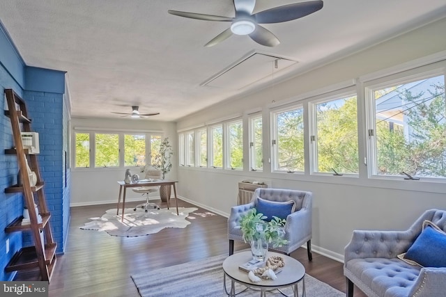 sunroom featuring ceiling fan and plenty of natural light