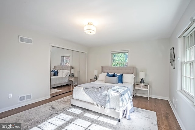 bedroom featuring a closet and dark hardwood / wood-style flooring