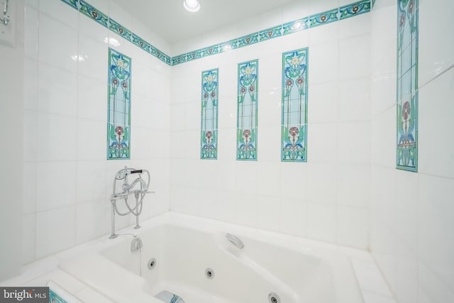 bathroom with tile walls and tiled bath