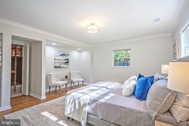 bedroom featuring crown molding and hardwood / wood-style floors