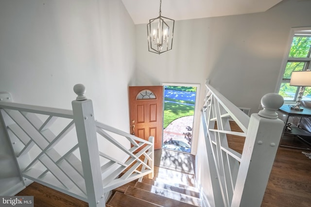 foyer entrance with a notable chandelier and dark wood-type flooring