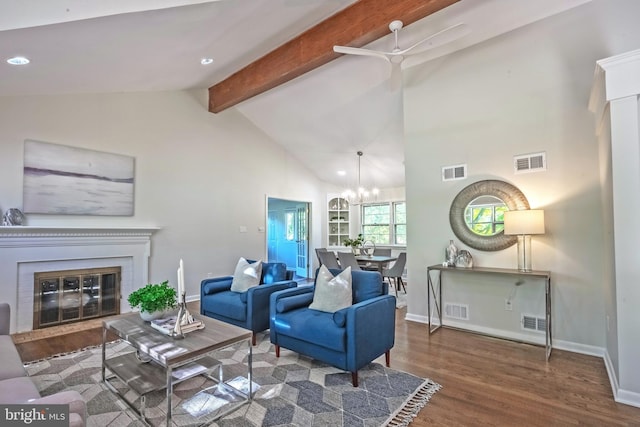 living room with dark wood-type flooring, vaulted ceiling with beams, and ceiling fan with notable chandelier