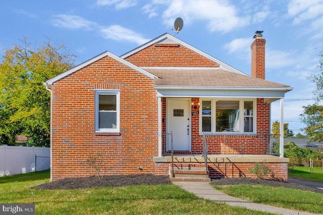 bungalow-style house featuring a front yard