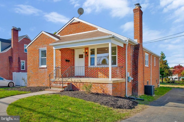 view of front of house with covered porch and cooling unit