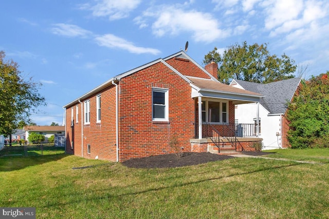 back of house with a lawn