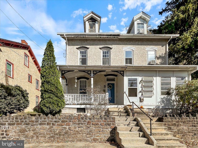 view of front of house featuring cooling unit and covered porch