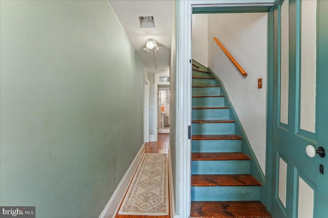 stairway with hardwood / wood-style floors