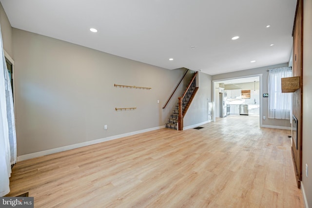 unfurnished living room with light hardwood / wood-style flooring