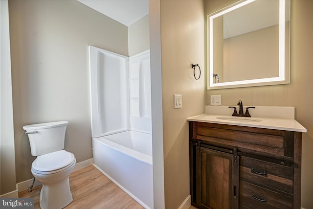 full bathroom with vanity, toilet, wood-type flooring, and washtub / shower combination