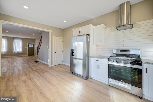 kitchen with appliances with stainless steel finishes, decorative backsplash, white cabinetry, and light hardwood / wood-style floors