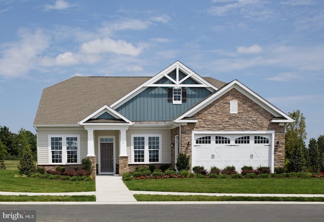 craftsman-style house with a front lawn and a garage