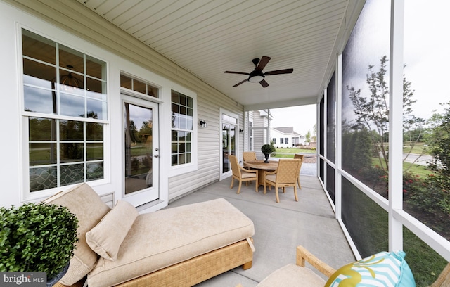 sunroom / solarium featuring ceiling fan