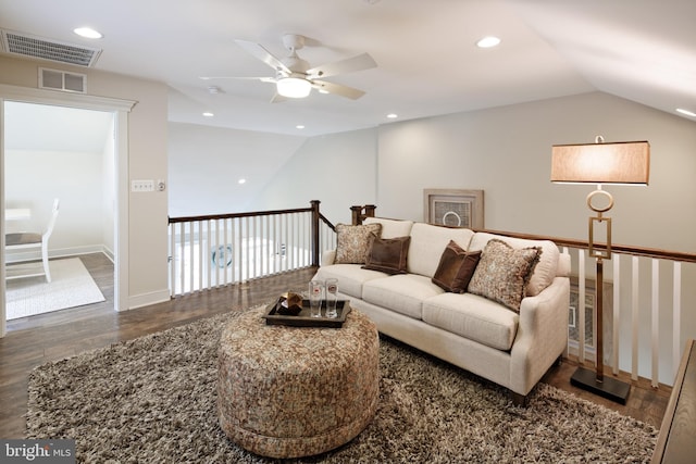 living room featuring ceiling fan, hardwood / wood-style flooring, and vaulted ceiling