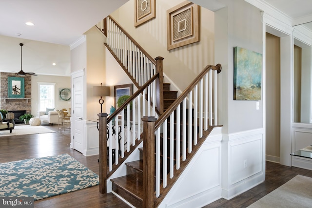 stairway with ornamental molding and hardwood / wood-style flooring