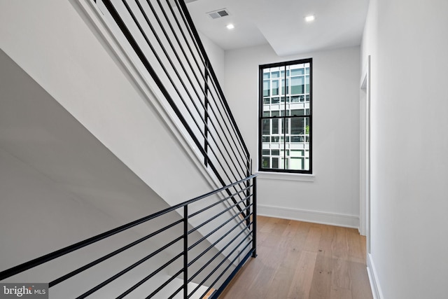 stairs featuring hardwood / wood-style floors