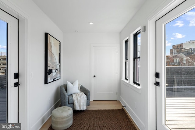 doorway to outside with light wood-type flooring