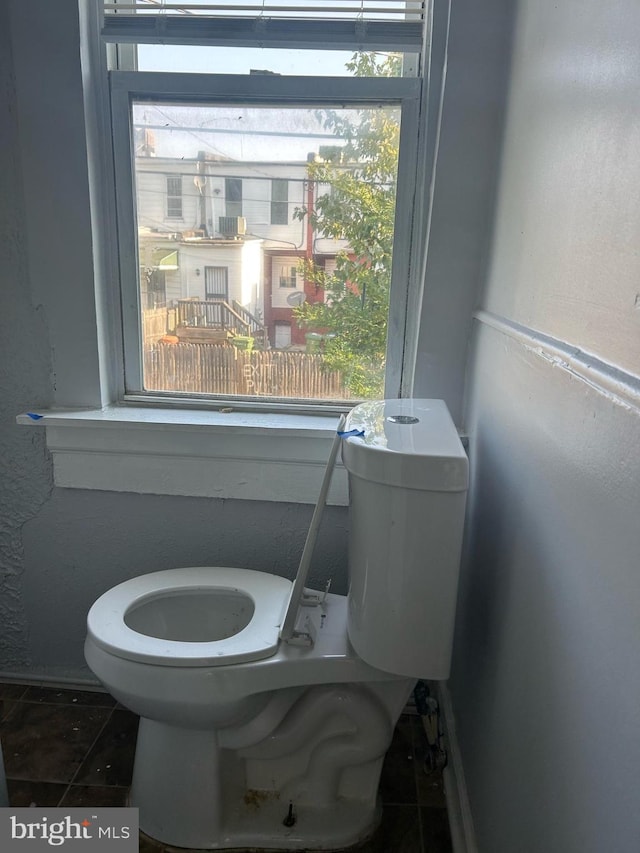 bathroom with toilet and tile patterned flooring