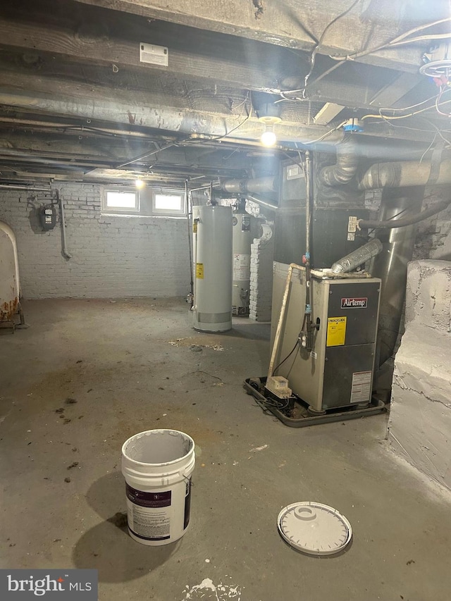 basement featuring heating unit and gas water heater