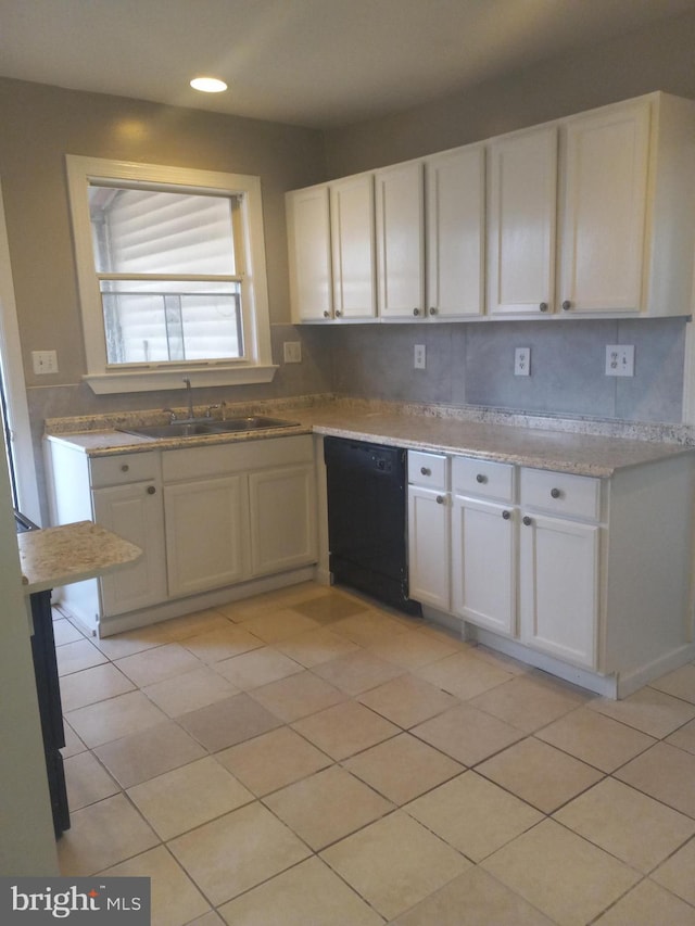 kitchen featuring white cabinetry, black dishwasher, sink, and light tile patterned floors