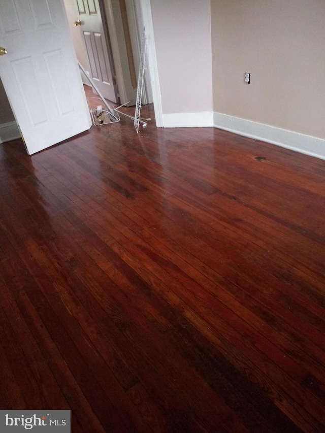 unfurnished room featuring dark hardwood / wood-style flooring