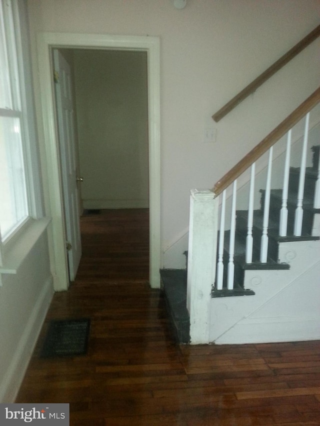 hall featuring dark wood-type flooring