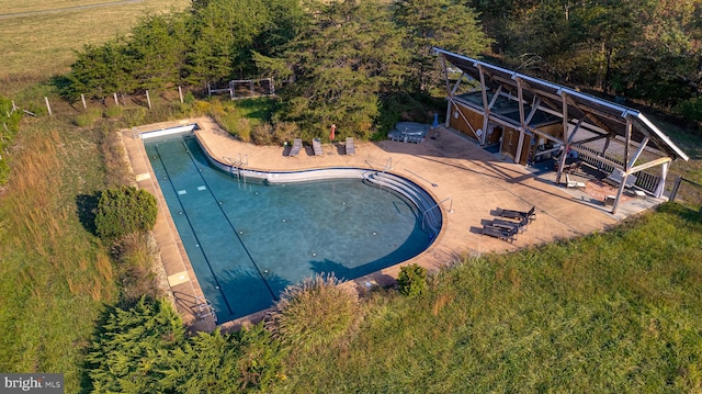 view of pool with a yard and a patio area