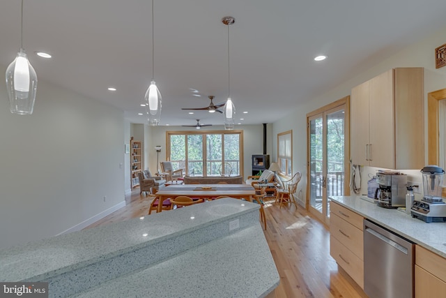 kitchen featuring stainless steel dishwasher, pendant lighting, light hardwood / wood-style flooring, and light stone countertops