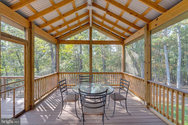 sunroom with vaulted ceiling with beams and plenty of natural light