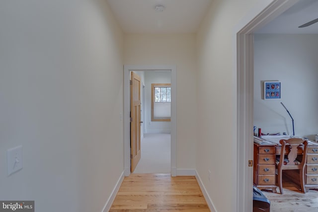 hallway with light hardwood / wood-style floors