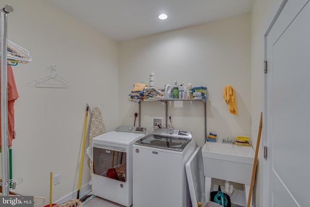 clothes washing area featuring independent washer and dryer