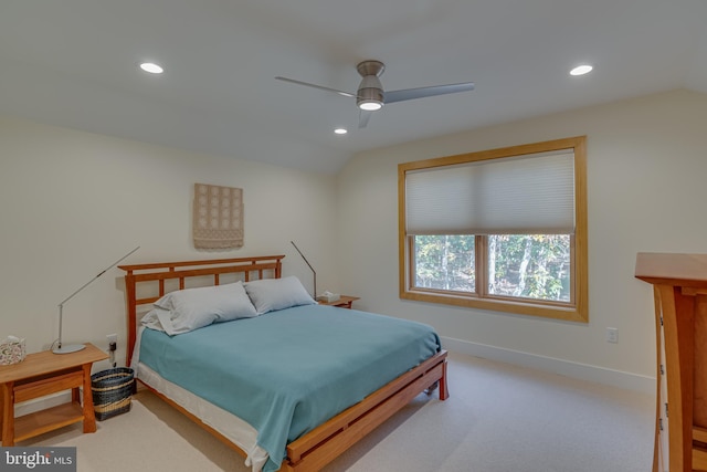 carpeted bedroom with ceiling fan and vaulted ceiling