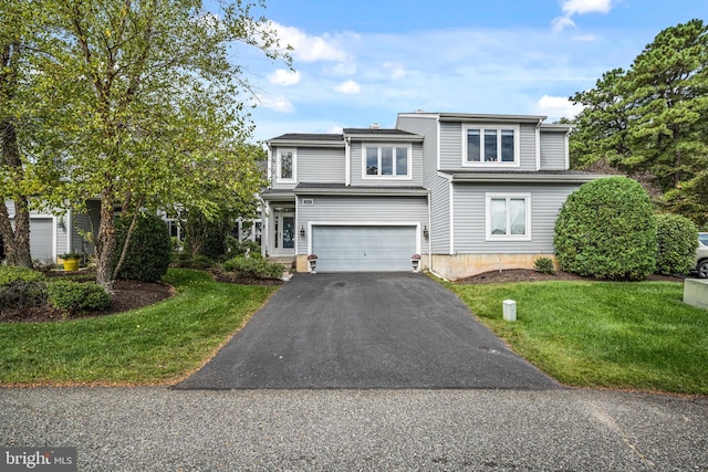 view of front facade featuring a front yard and a garage