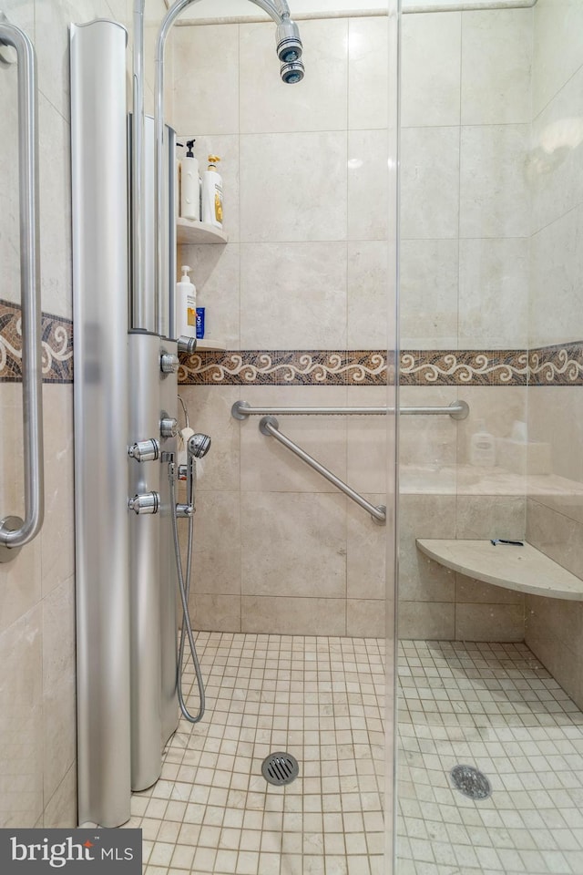 bathroom featuring a shower with door