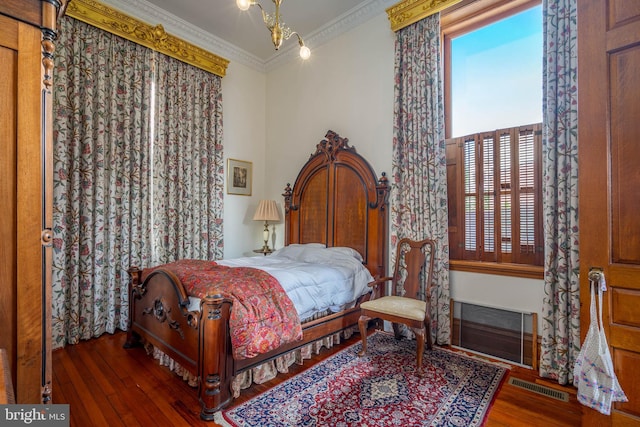 bedroom featuring ornamental molding and dark hardwood / wood-style flooring