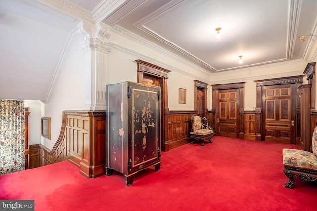 sitting room with ornamental molding and carpet