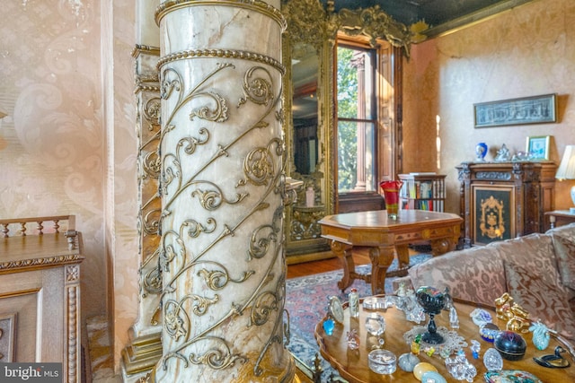 sitting room featuring hardwood / wood-style floors and ornate columns