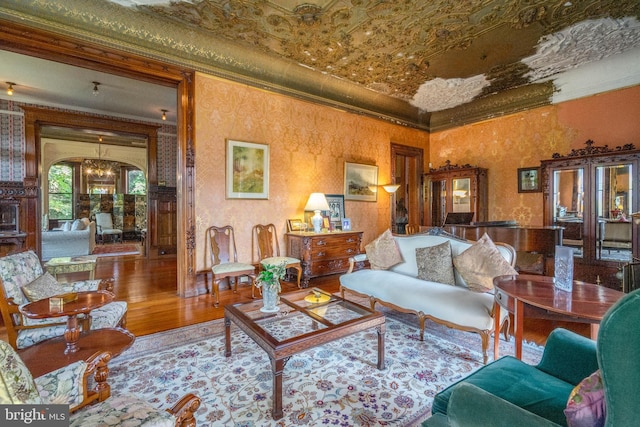 living room with crown molding and hardwood / wood-style flooring